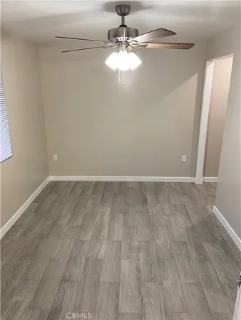 a view of a room with wooden floor and chandelier