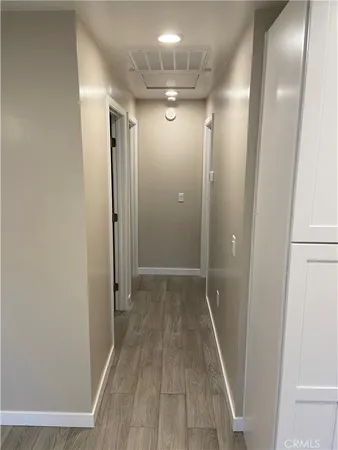 a view of hallway with wooden floor