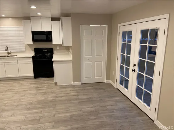 a view of a kitchen with a sink and a stove top oven