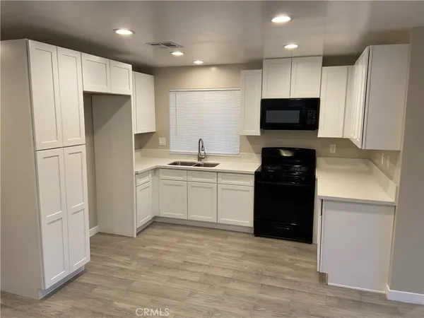 a kitchen with a refrigerator and a stove