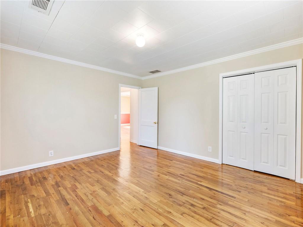 1686 Shoal Creek Road Monroe, GA 30656 - Photo 19 of 50 a view of an empty room with wooden floor