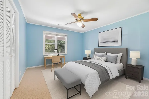 a bedroom with a large bed and a window