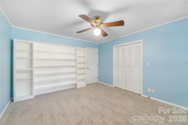 a view of an empty room with a ceiling fan