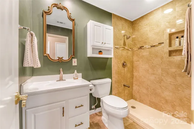 a bathroom with a sink vanity mirror and toilet