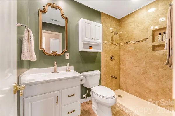 a bathroom with a sink vanity mirror and toilet