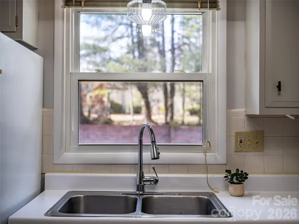 a kitchen with a sink and large window