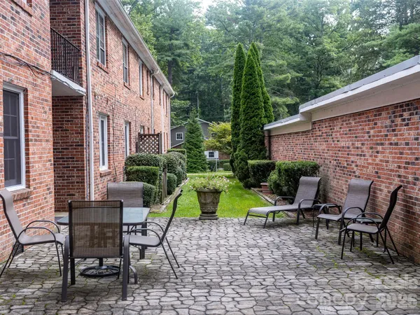 a view of backyard with outdoor seating and plants