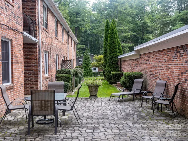 a view of backyard with outdoor seating and plants