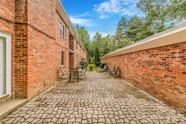 a backyard of a house with table and chairs