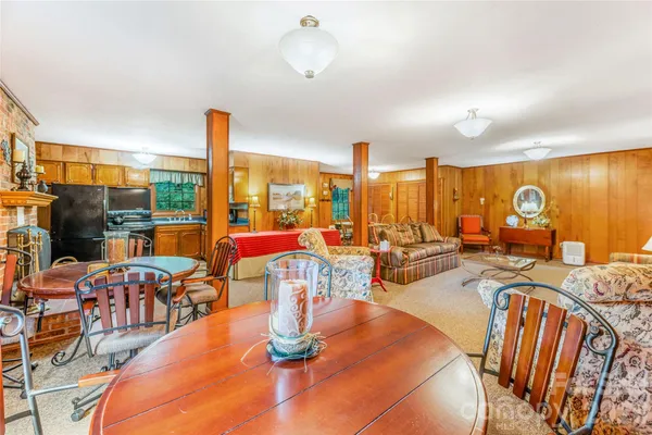 a dining room with furniture water view and large windows