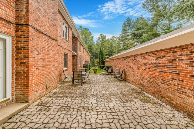 a backyard of a house with table and chairs