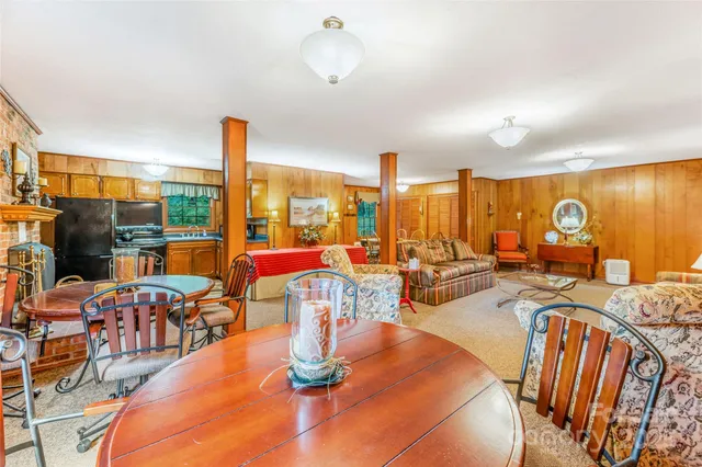 a dining room with furniture water view and large windows