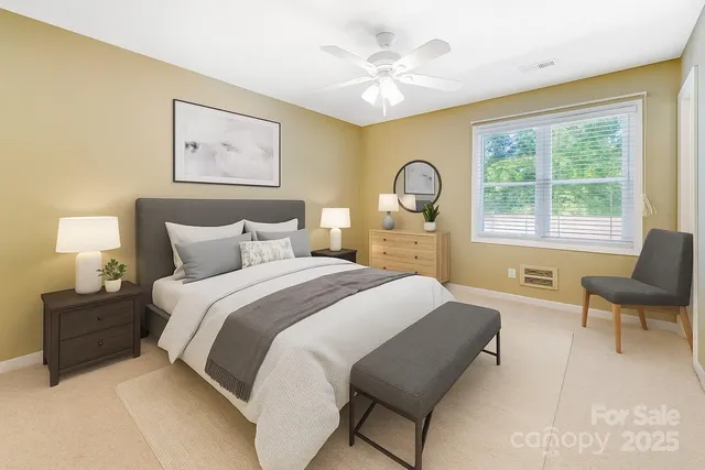 a bedroom with a bed and a large window