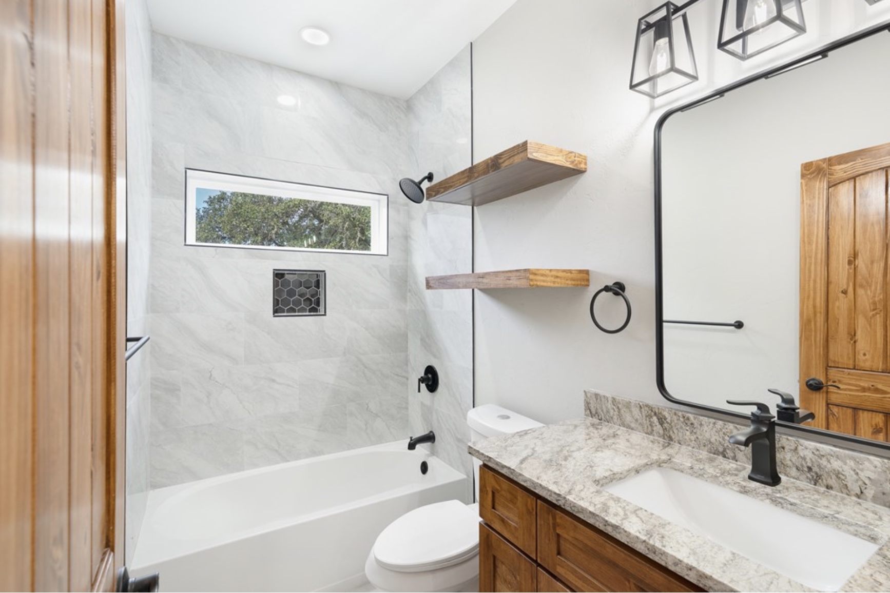 288 Nott Branch Road Harper, TX 78631 - Photo 16 of 27 a bathroom with a granite countertop sink toilet and shower