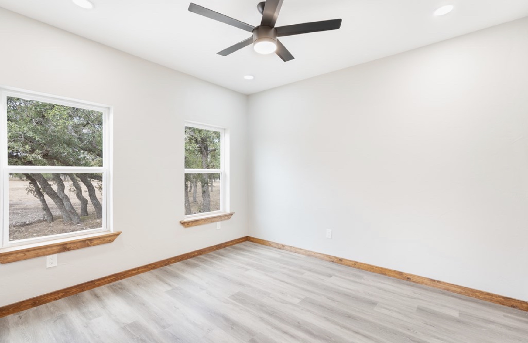 288 Nott Branch Road Harper, TX 78631 - Photo 17 of 27 a view of an empty room with a window and wooden floor