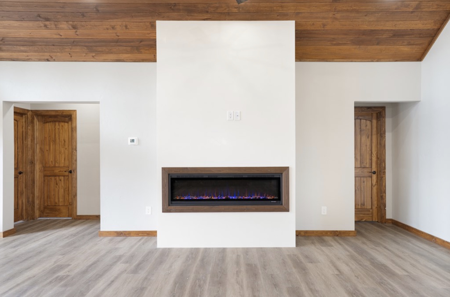 288 Nott Branch Road Harper, TX 78631 - Photo 22 of 27 a living room with wooden floor and a fireplace