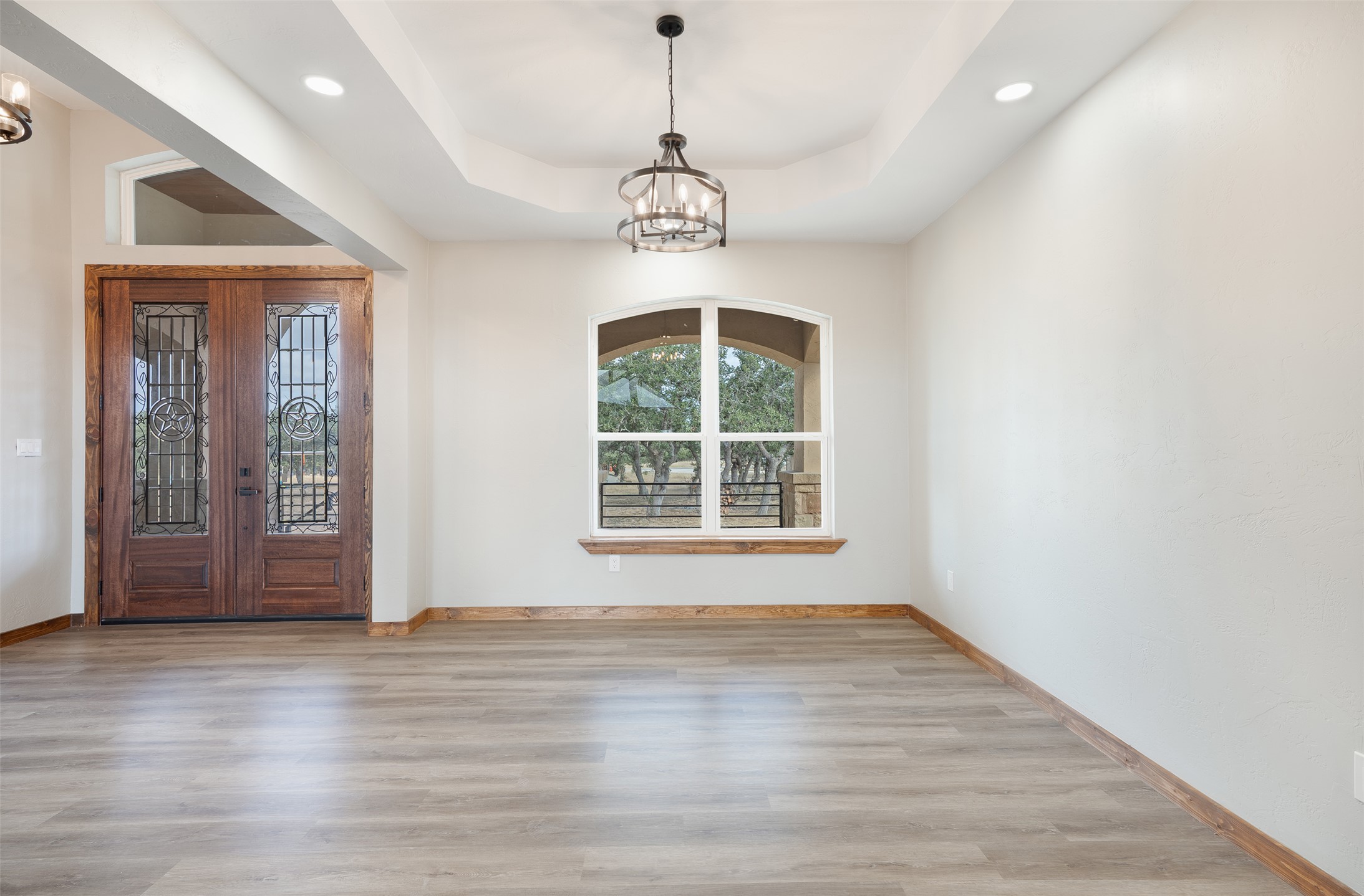 288 Nott Branch Road Harper, TX 78631 - Photo 7 of 27 a view of an empty room with wooden floor and a window