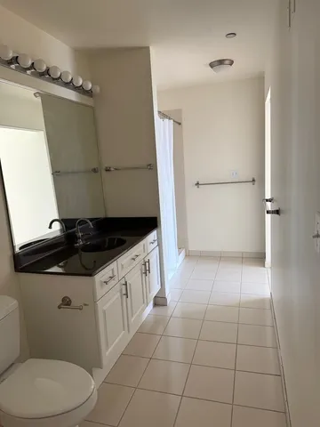 a bathroom with a sink a toilet and a shower