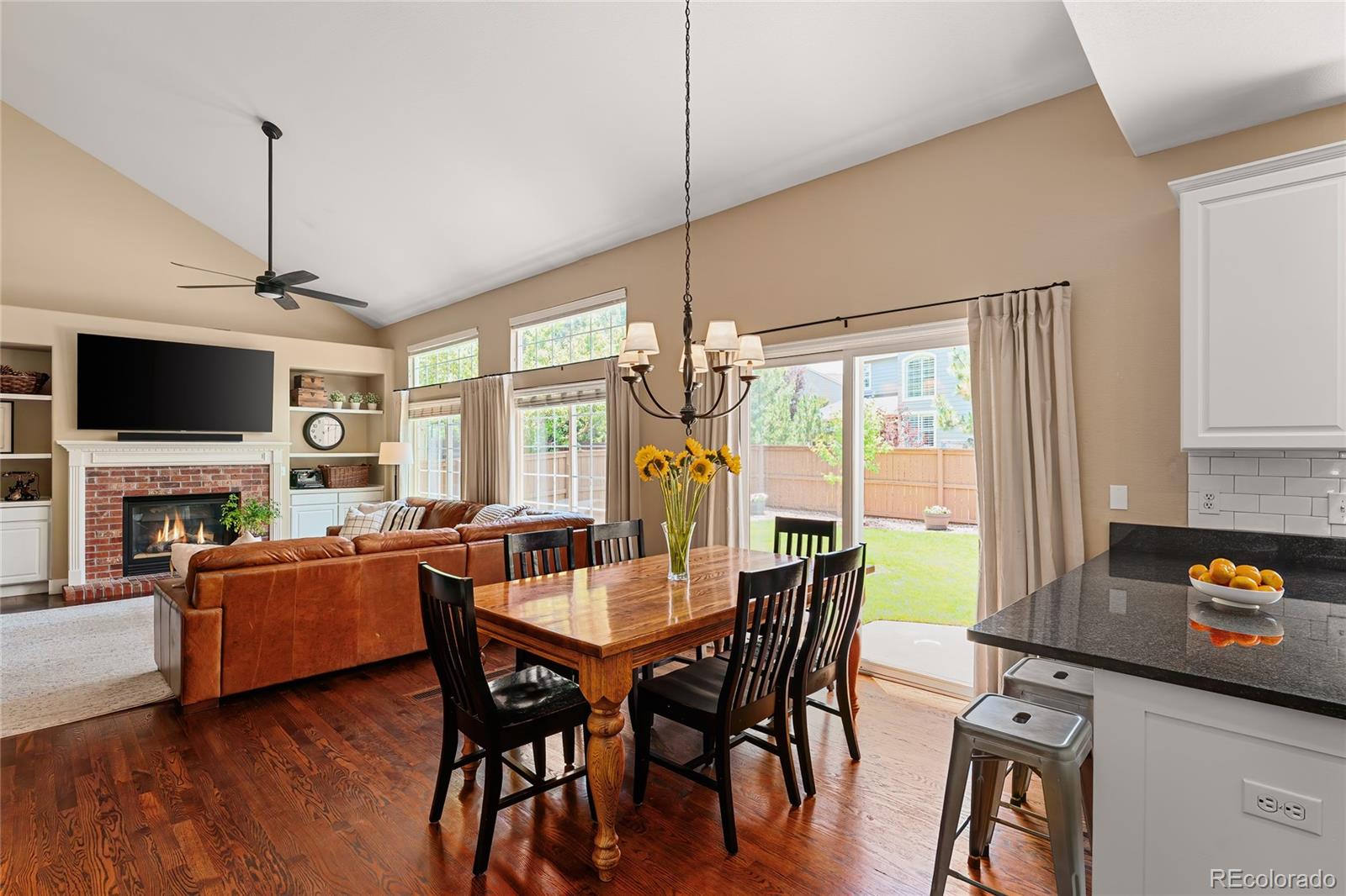 9441 South Hackberry Lane Highlands Ranch, CO 80129 - Photo 20 of 50 a view of a dining room with furniture window and wooden floor