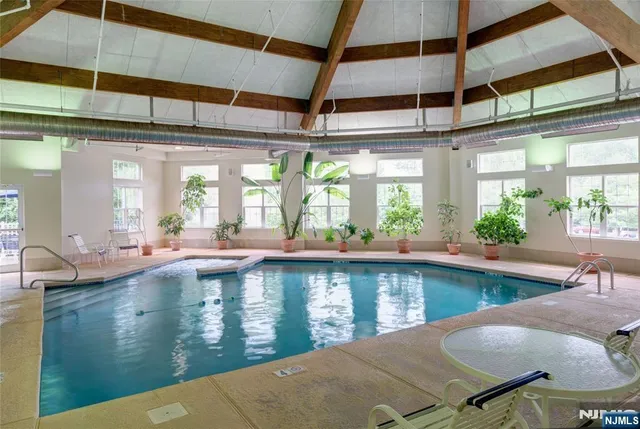 a large swimming pool with a outdoor seating