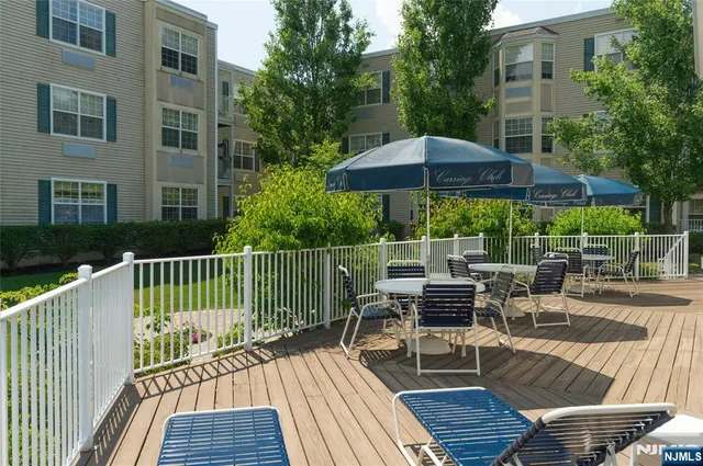 a view of a chairs and table on the wooden deck