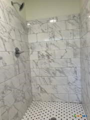 907 East 3rd Street, Unit A Lampasas, TX 76550 - Photo 11 of 13 a bathroom with a shower