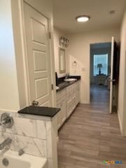 907 East 3rd Street, Unit A Lampasas, TX 76550 - Photo 13 of 13 a kitchen with granite countertop a stove and cabinets