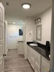 a bathroom with a sink a mirror and a shower