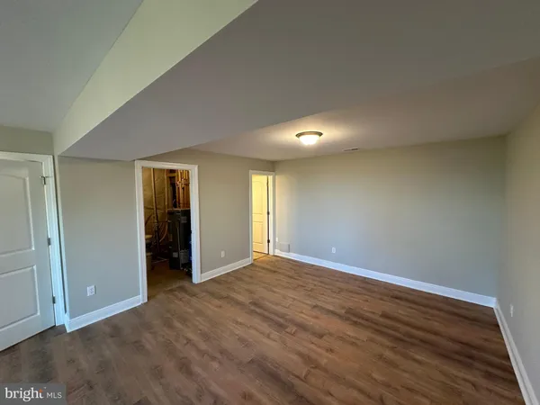 an empty room with wooden floor and closet