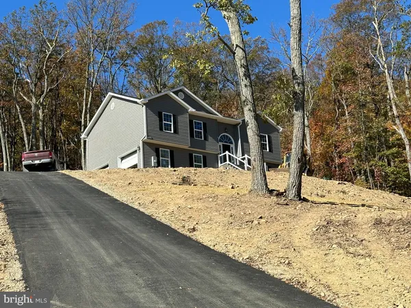a view of a house with snow on the road