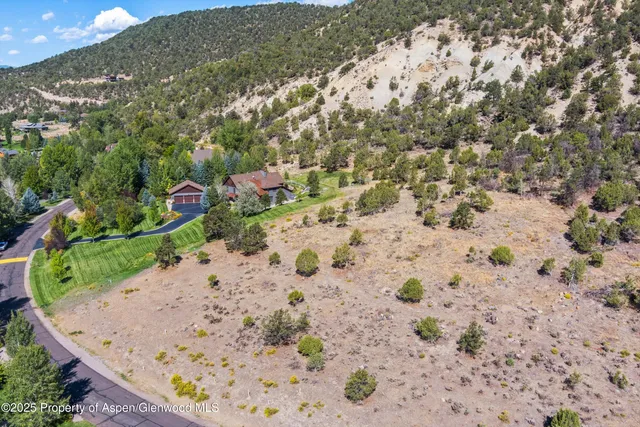 a view of a wooden house with a yard