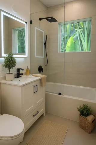 a bathroom with a sink a mirror toilet and bathtub