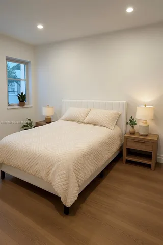 a bedroom with a bed and a view of kitchen