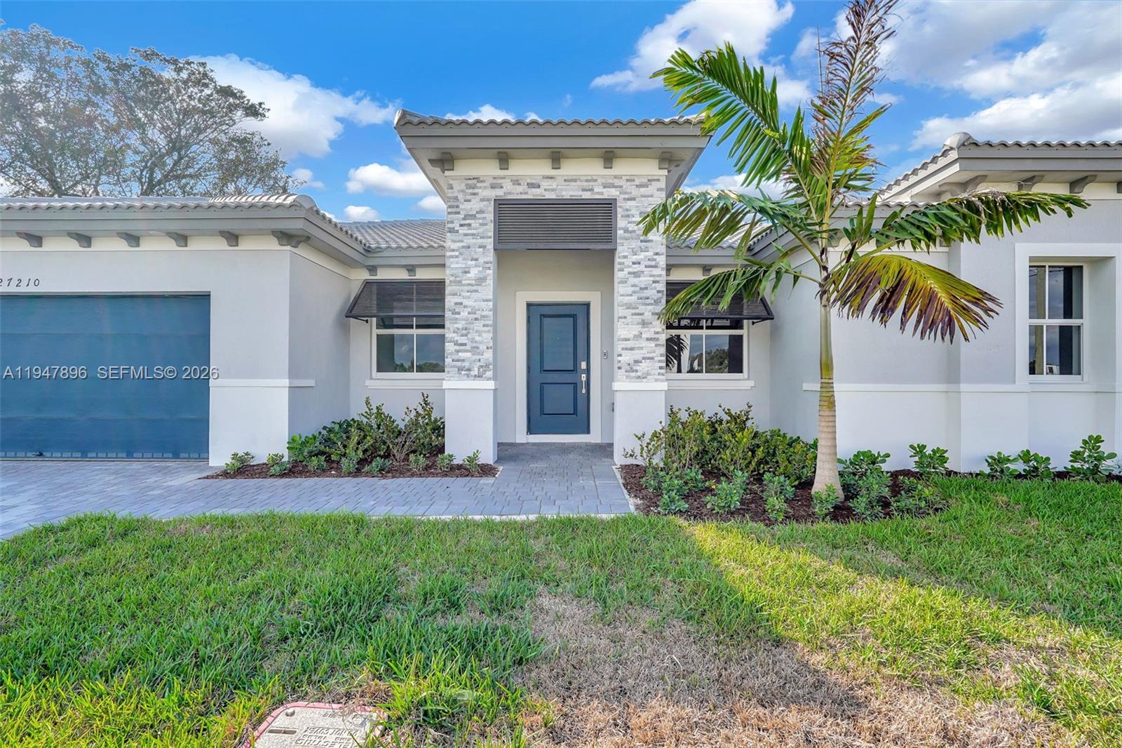27210 Southwest 159th Path Homestead, FL 33031 - Photo 11 of 100 front view of a house with a garden