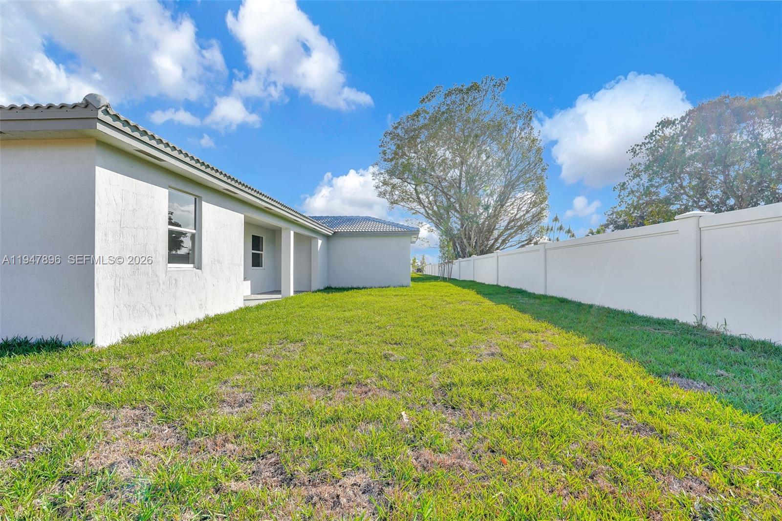 27210 Southwest 159th Path Homestead, FL 33031 - Photo 22 of 100 a view of a house with backyard and a tree