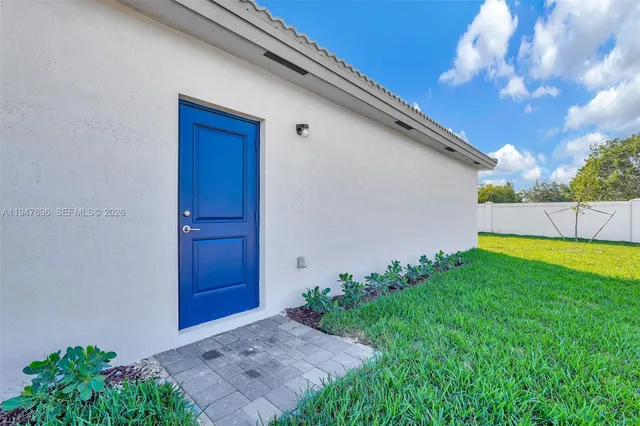 a view of a big room with wooden floor and windows