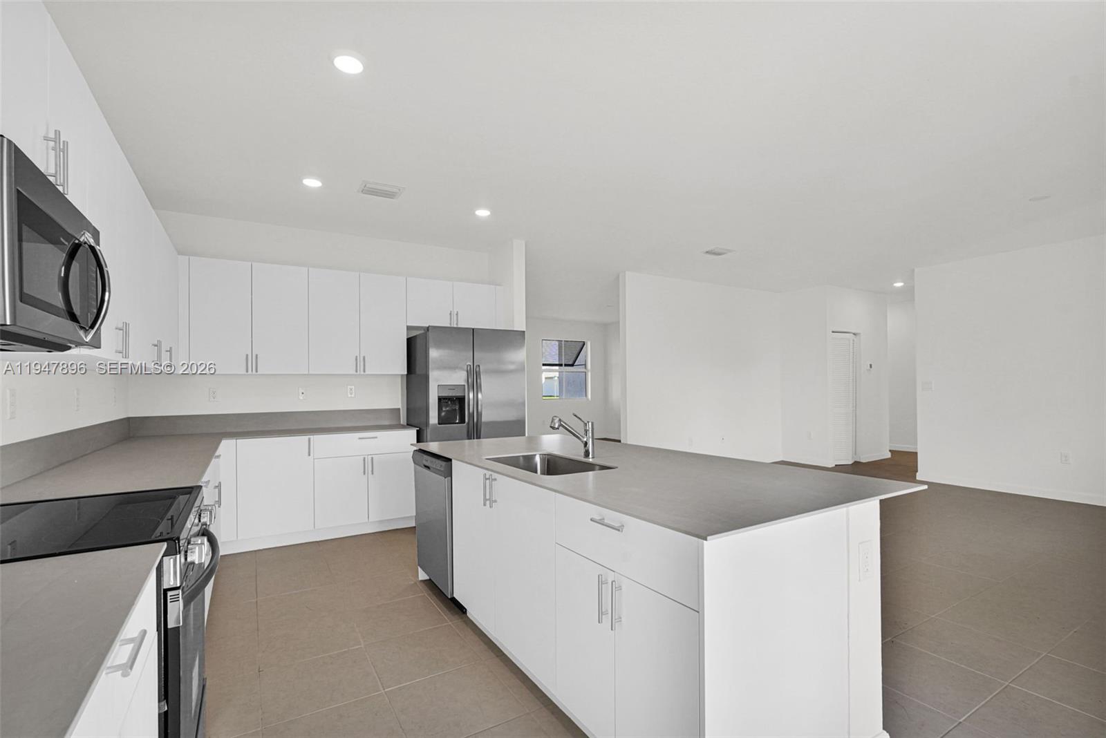 27210 Southwest 159th Path Homestead, FL 33031 - Photo 40 of 100 a kitchen that has a sink and a stove in it