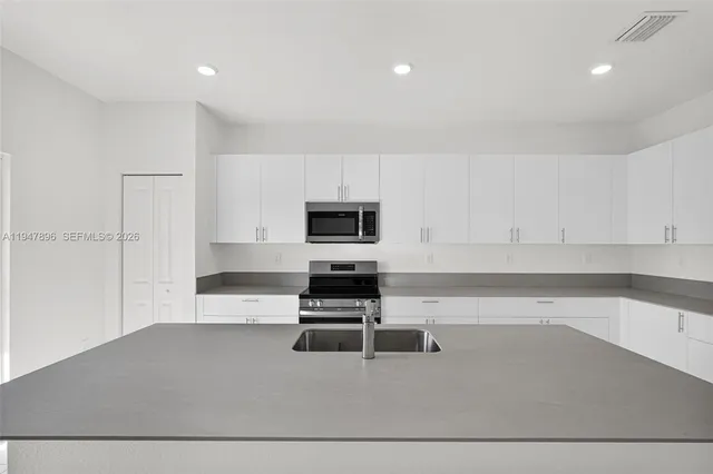 a bedroom with a bed and a potted plant