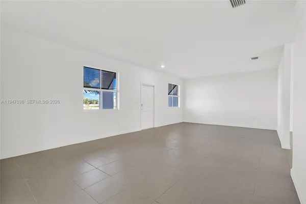 a view of kitchen with kitchen island stainless steel appliances refrigerator sink and cabinets