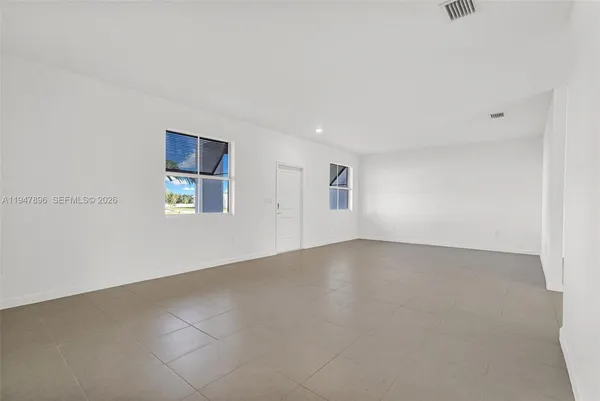 a living room with furniture and kitchen view