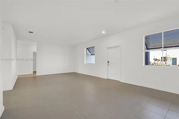 a view of kitchen with refrigerator sink and white cabinets