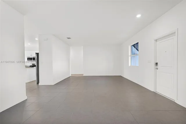 a kitchen with stainless steel appliances a refrigerator sink and microwave