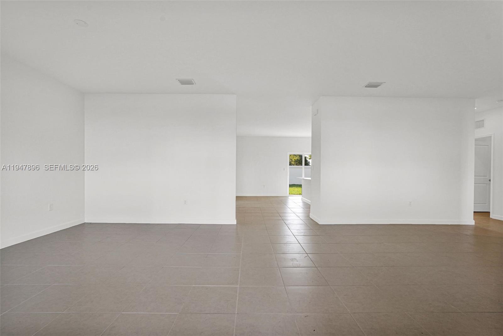 27210 Southwest 159th Path Homestead, FL 33031 - Photo 50 of 100 a view of a big room with wooden floor and windows