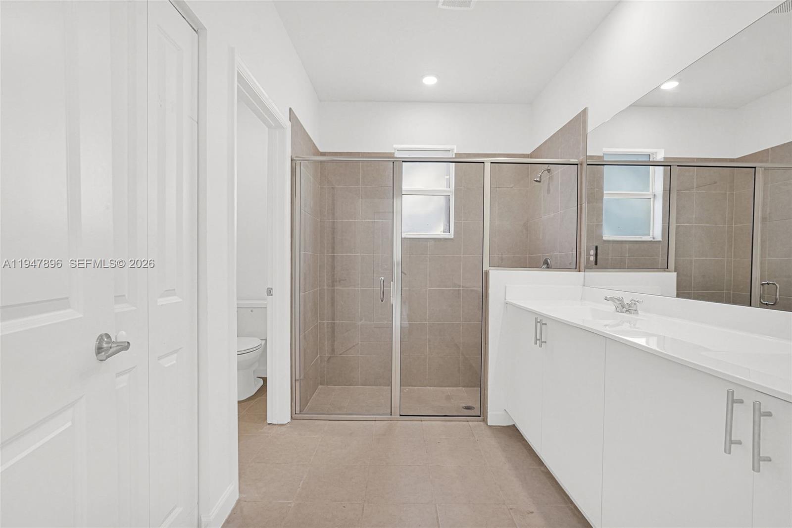 27210 Southwest 159th Path Homestead, FL 33031 - Photo 68 of 100 a bathroom with a sink a mirror and a shower