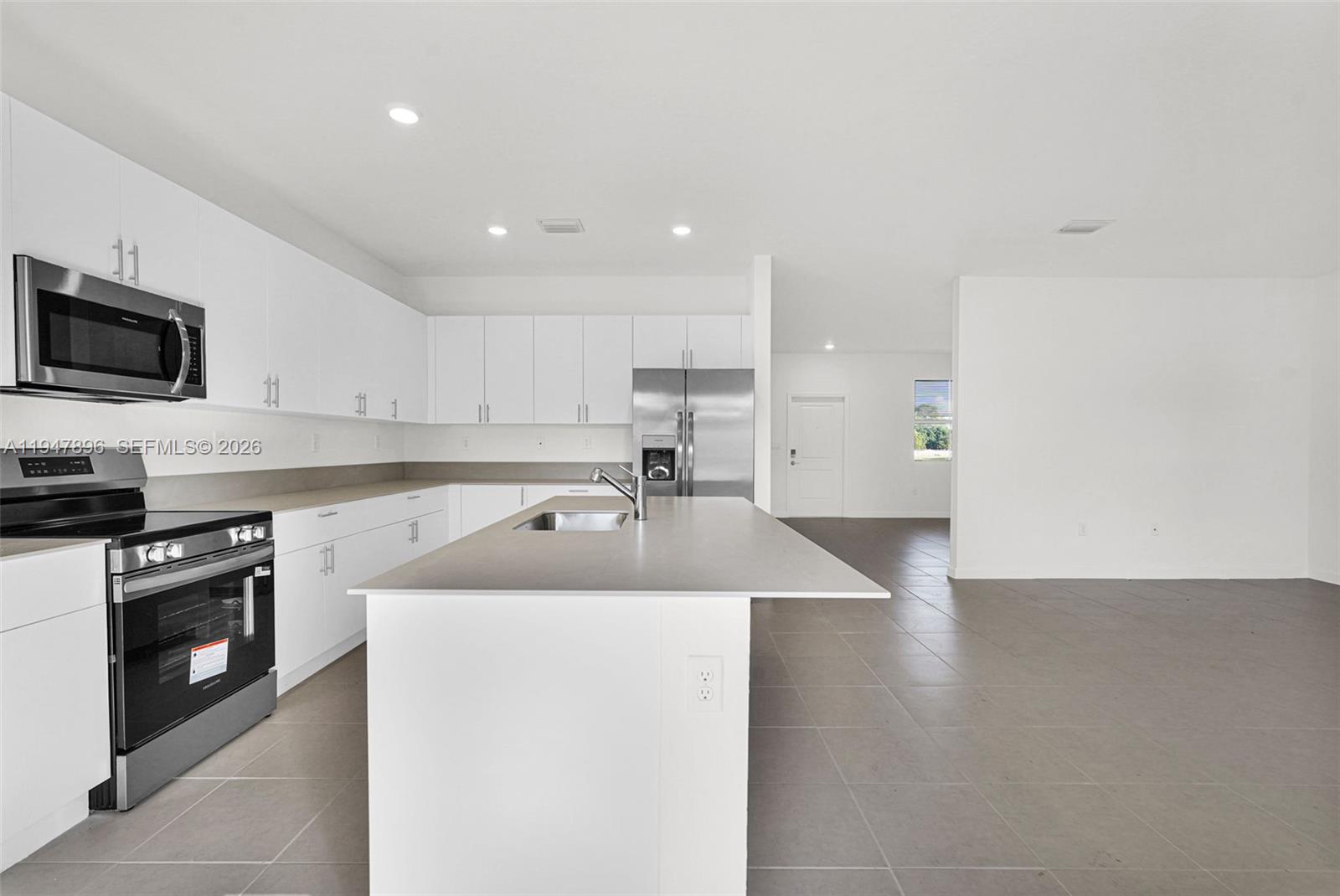 27210 Southwest 159th Path Homestead, FL 33031 - Photo 71 of 100 a kitchen with a sink a stove and refrigerator
