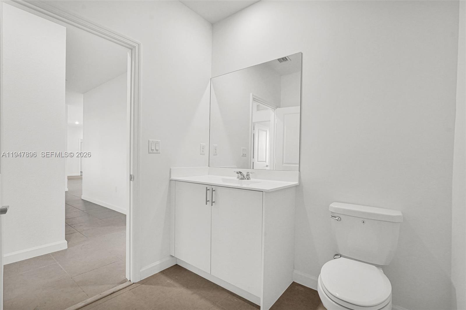 27210 Southwest 159th Path Homestead, FL 33031 - Photo 81 of 100 a bathroom with a toilet a sink and mirror