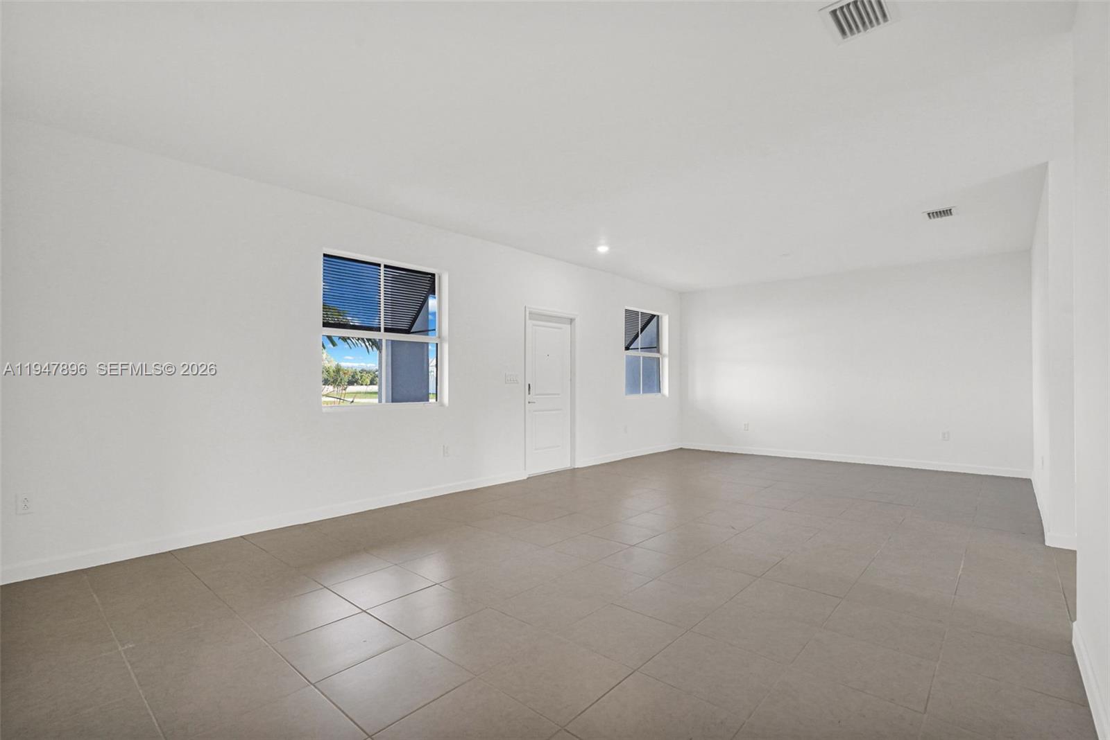 27210 Southwest 159th Path Homestead, FL 33031 - Photo 82 of 100 an empty room with windows