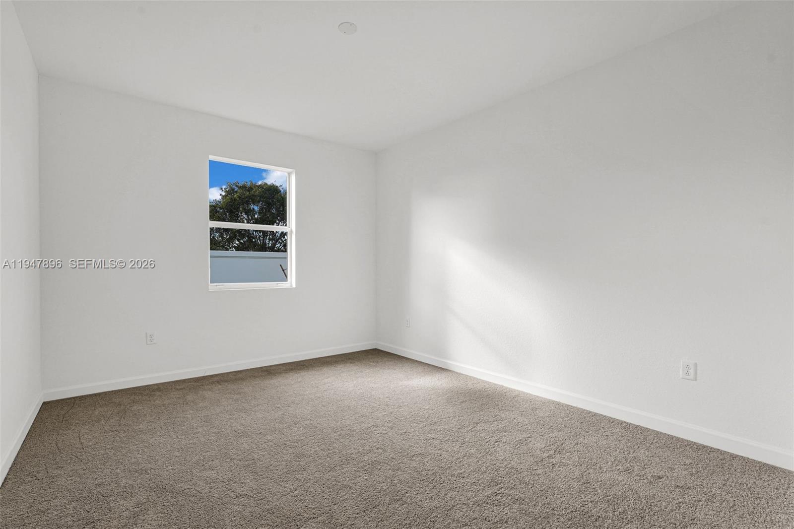 27210 Southwest 159th Path Homestead, FL 33031 - Photo 85 of 100 a view of an empty room with a window