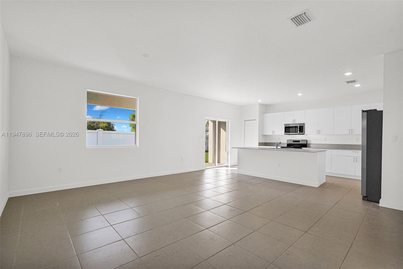 27210 Southwest 159th Path Homestead, FL 33031 - Photo 91 of 100 a view of kitchen with kitchen island stainless steel appliances refrigerator sink and cabinets