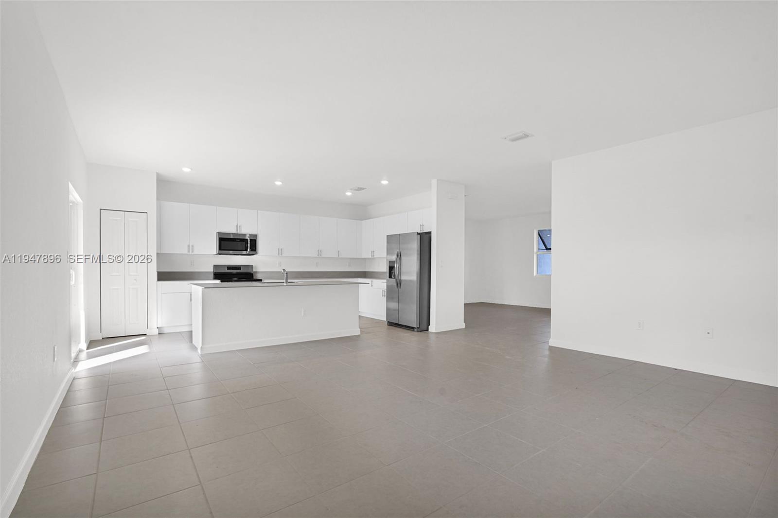 27210 Southwest 159th Path Homestead, FL 33031 - Photo 94 of 100 a view of kitchen with refrigerator sink and white cabinets